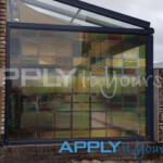 Stained glass window design on transparent window film for a house extension